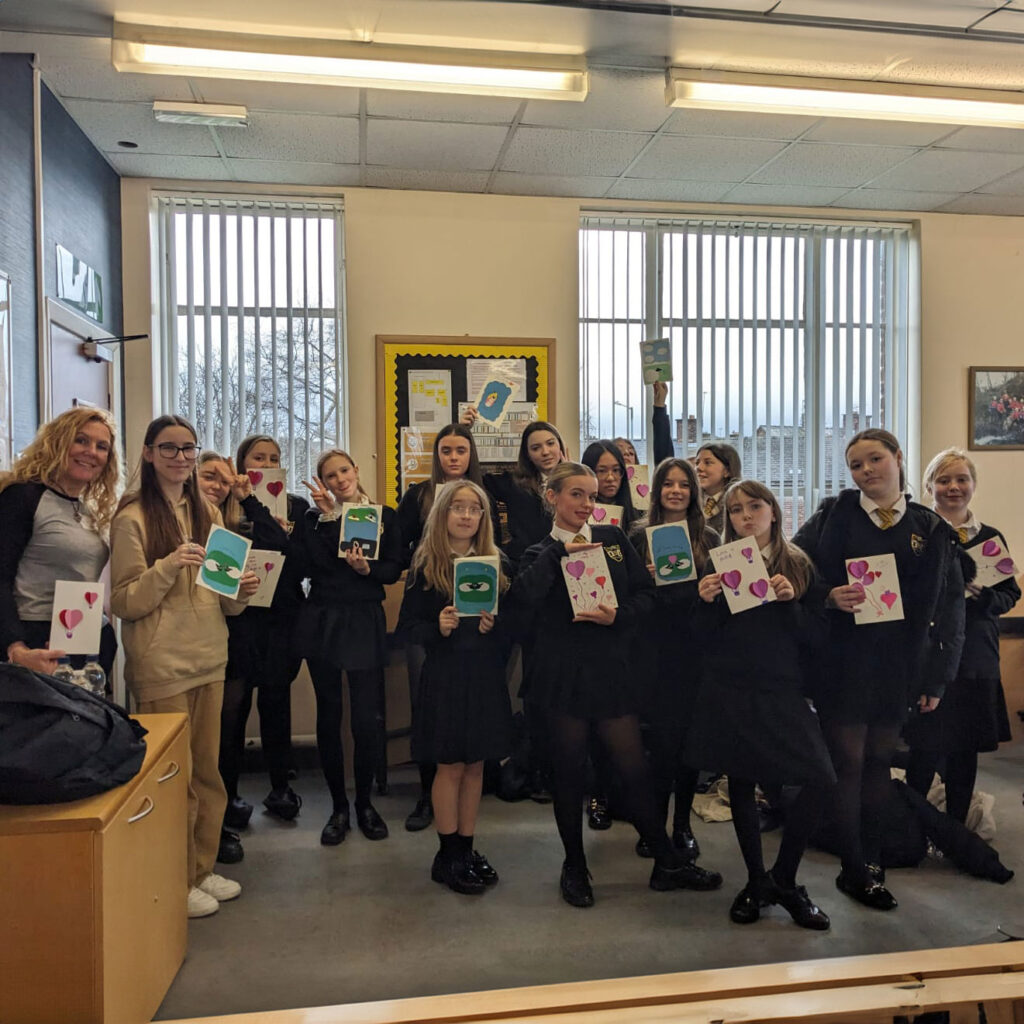 Young and Mindful in a classroom with students showing what they made during the session