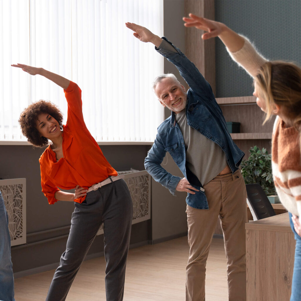 Three adults, smiling and stretching